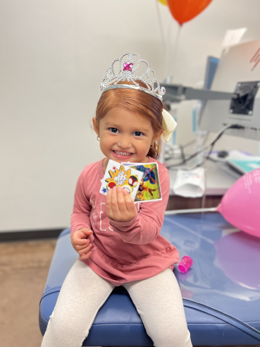 Happy Gladstone Patient with Prizes